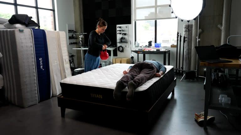 Sleep Foundation tester lying on the Brooklyn Bedding Titan Plus mattress