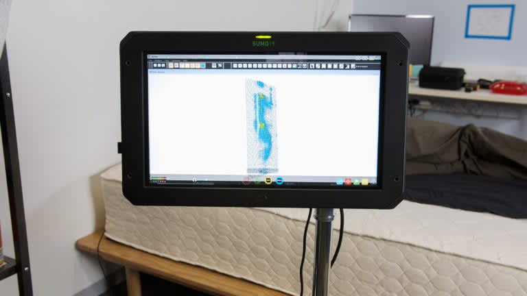 Sleep Foundation tester undergoing side-sleeping pressure mapping on the WinkBeds EcoCloud mattress