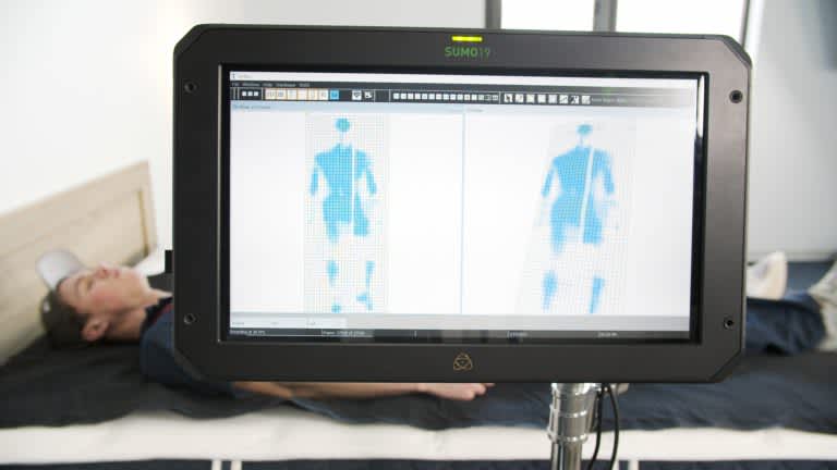Sleep Foundation tester undergoing back-sleeping pressure mapping on the Brooklyn Bedding Signature mattress