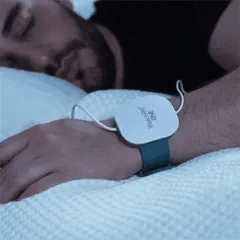 A photo of a man sleeping with a WatchPAT One at home sleep apnea test