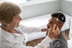 Doctor preparing a patient for a sleep study